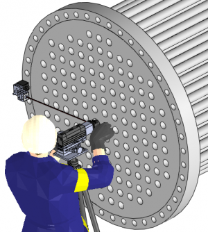 Technician in blue with a yellow armband operates a large industrial perforated disk using a mounting tool on a tall cylindrical apparatus.